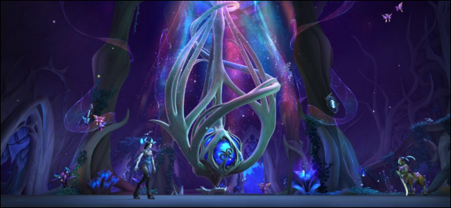 A scene from World of Warcraft heavy with blues and purples, magical beings surrounding a large blue orb.