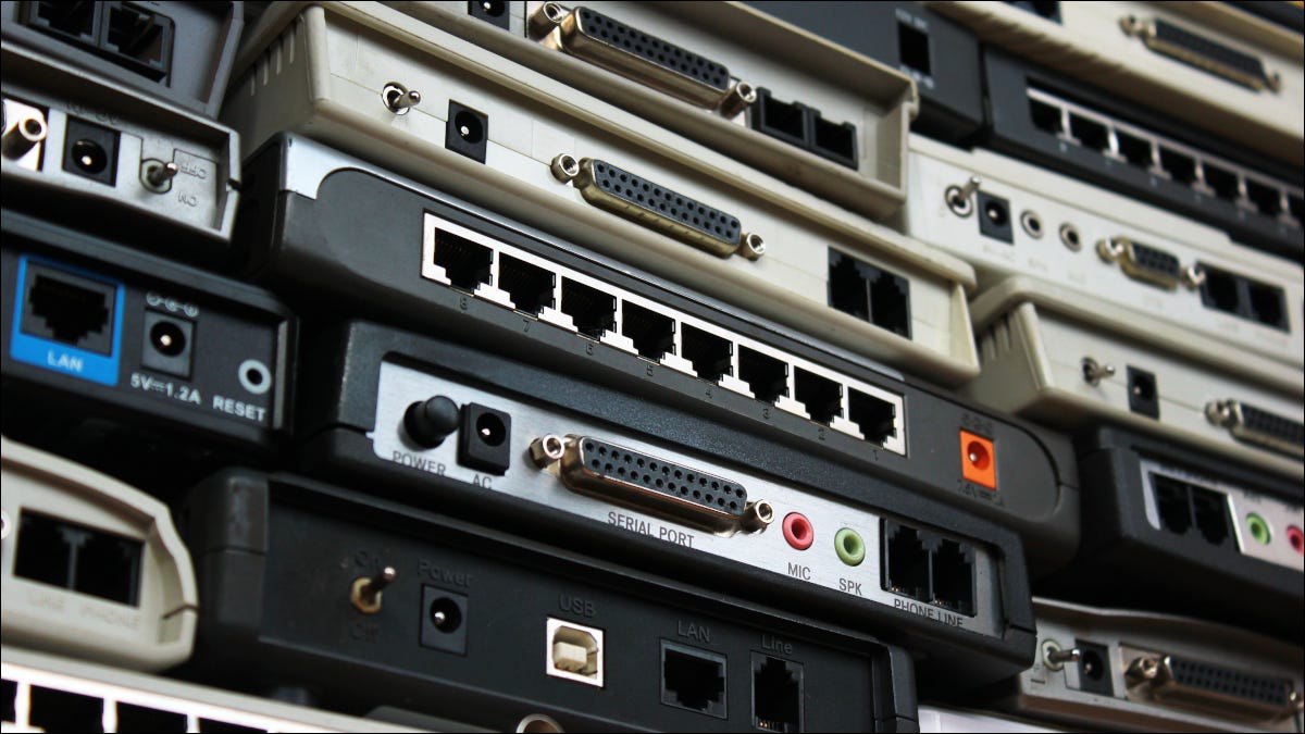 Closeup of a wall of old network routers and modems