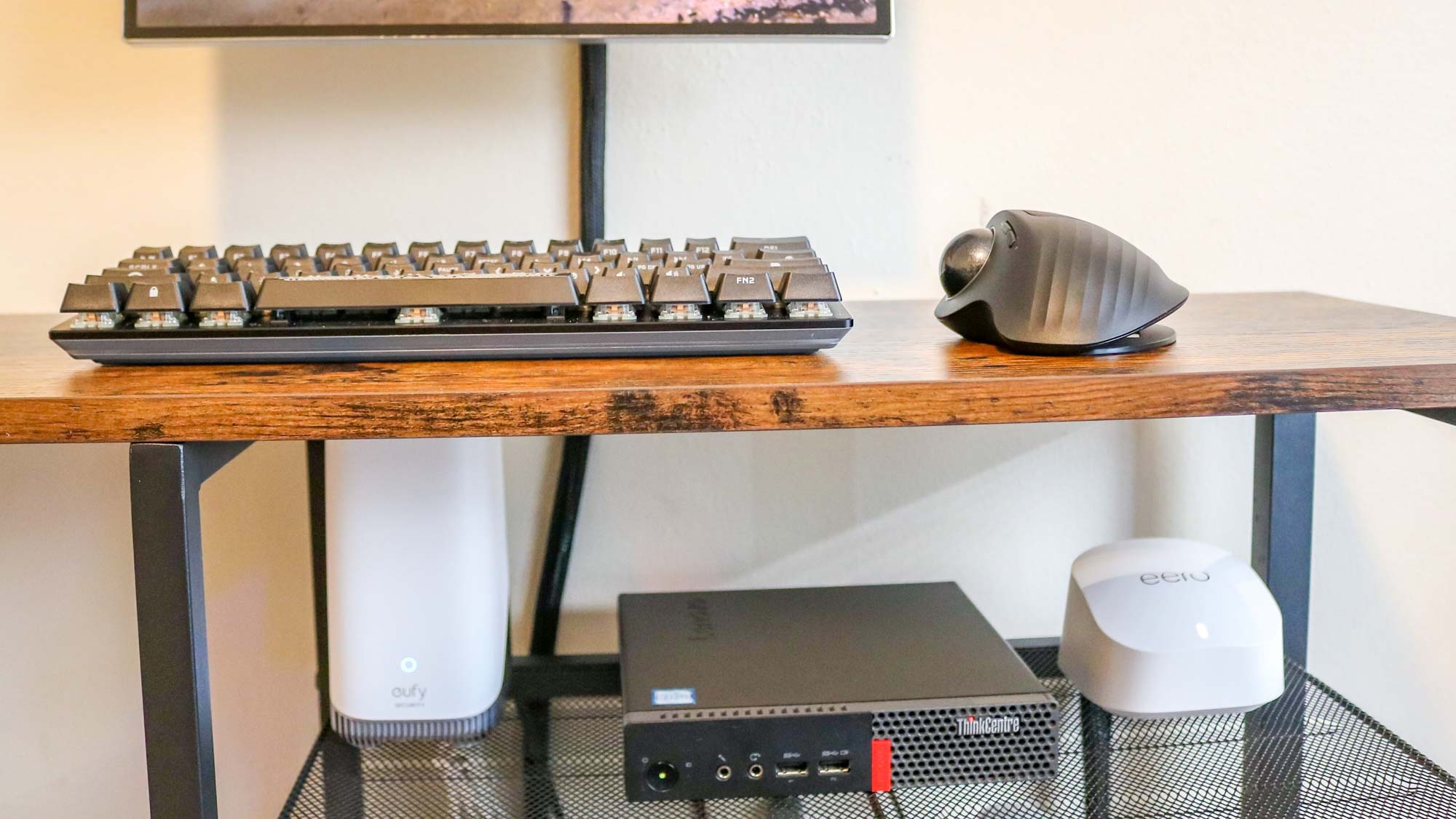 A Lenovo ThinkCentre Tiny next to a mesh router