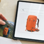 A hand places a vacation photo and envelope beside a tablet showing a similar hiking backpack in a generic shopping result, illustrating private-content insights used for advertising.